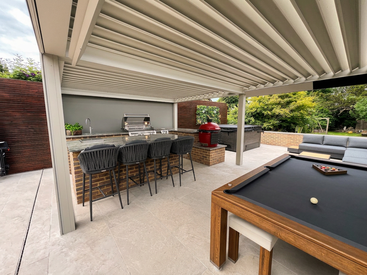Pergola-covered outdoor kitchen and bar with pool table and lounge seating beyond