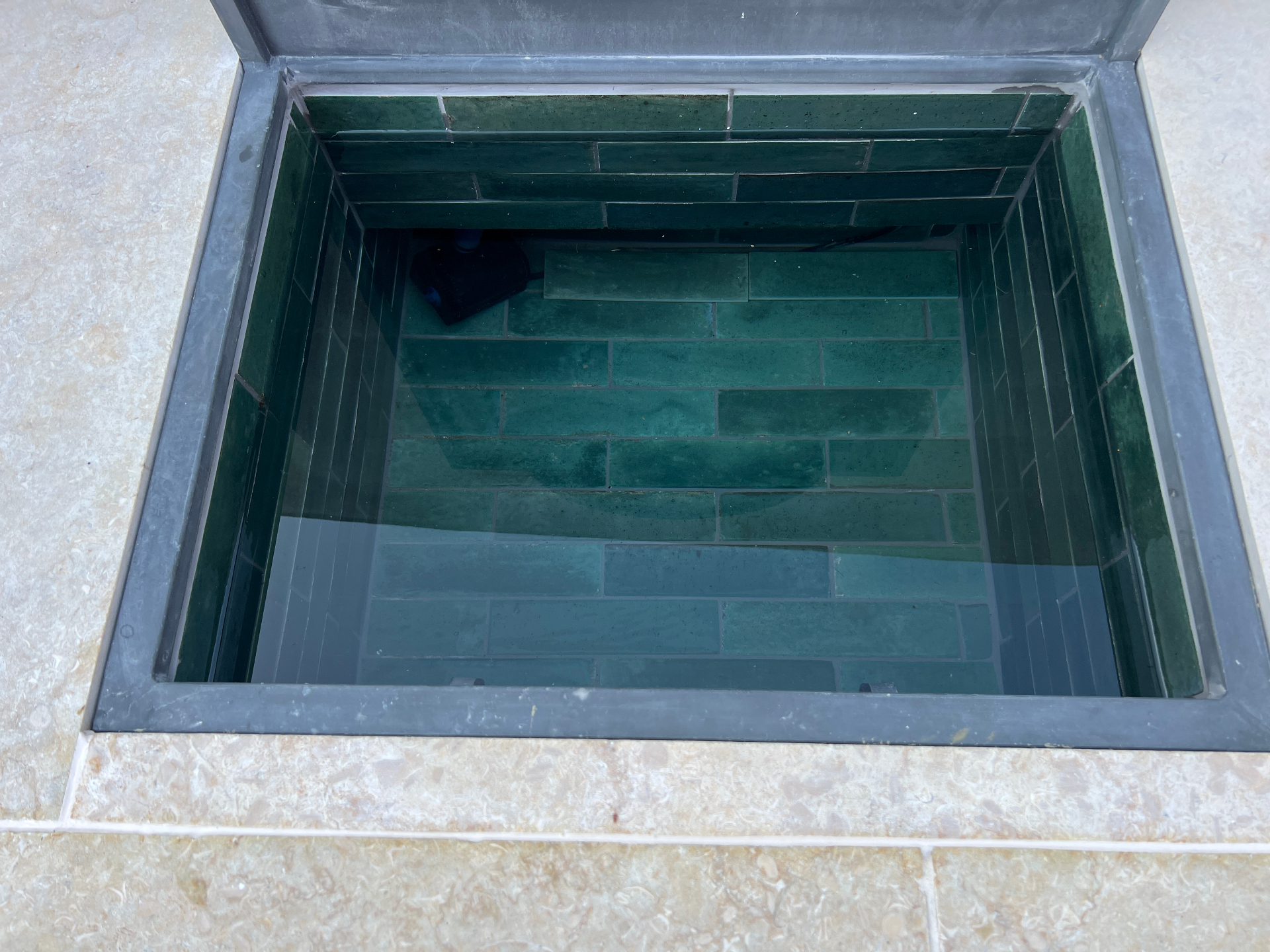 Medi Garden — close-up of the recessed basin lined with emerald green glazed tiles