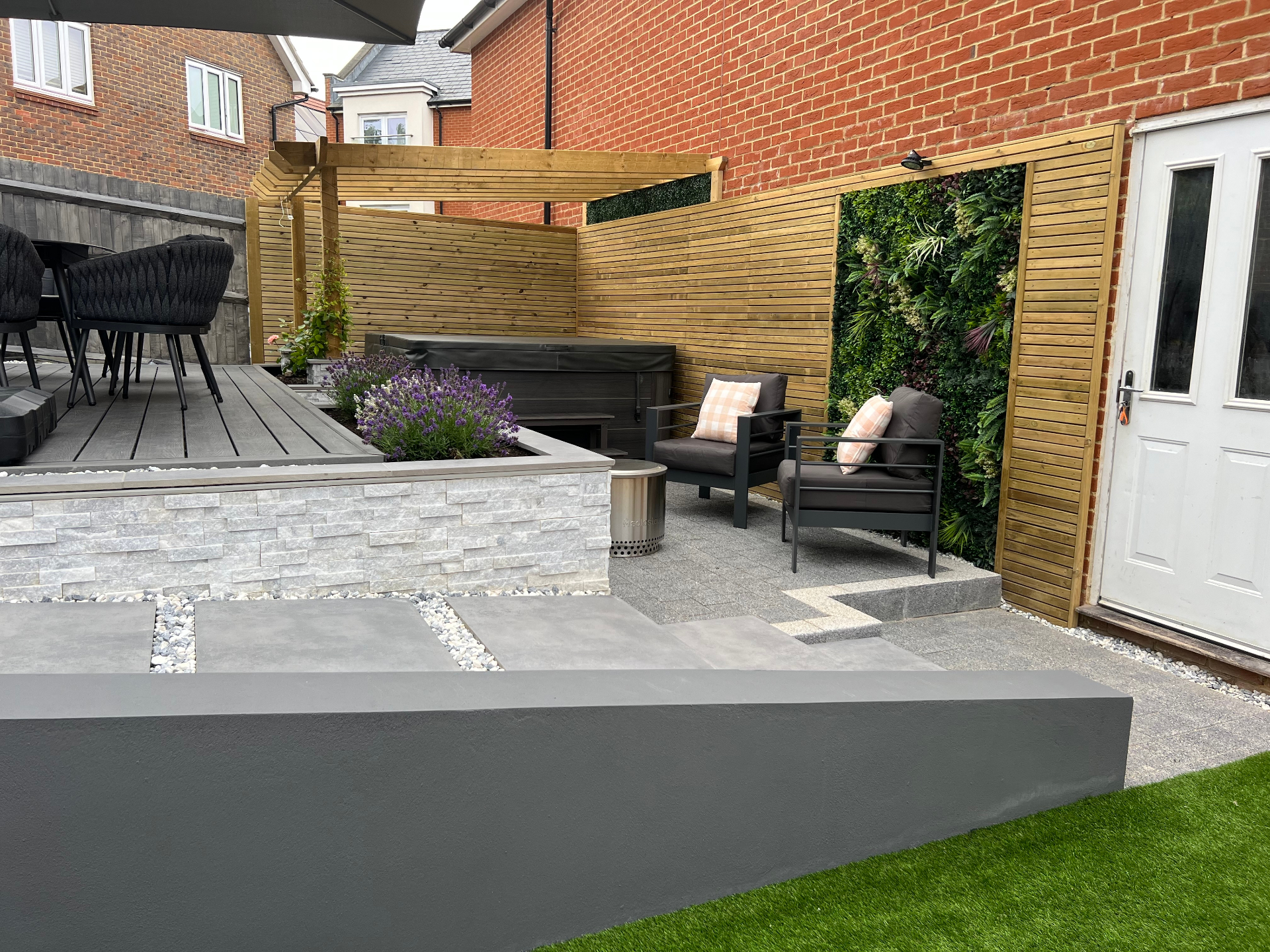 Finished garden — raised entertaining deck beside a living wall and secluded lounge seating