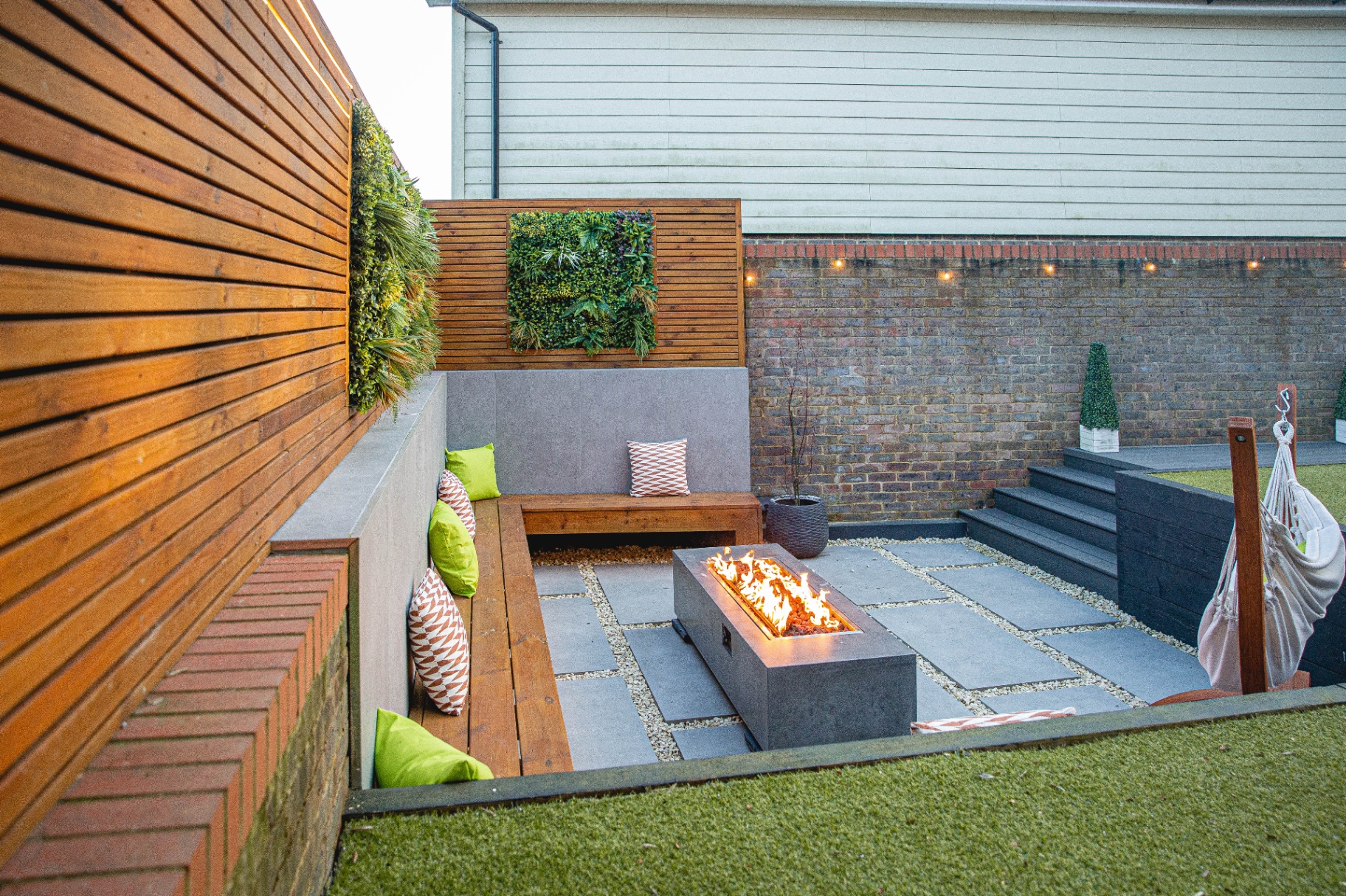 Elevated view of the sunken seating area, fire pit and bordering lawn with hammock