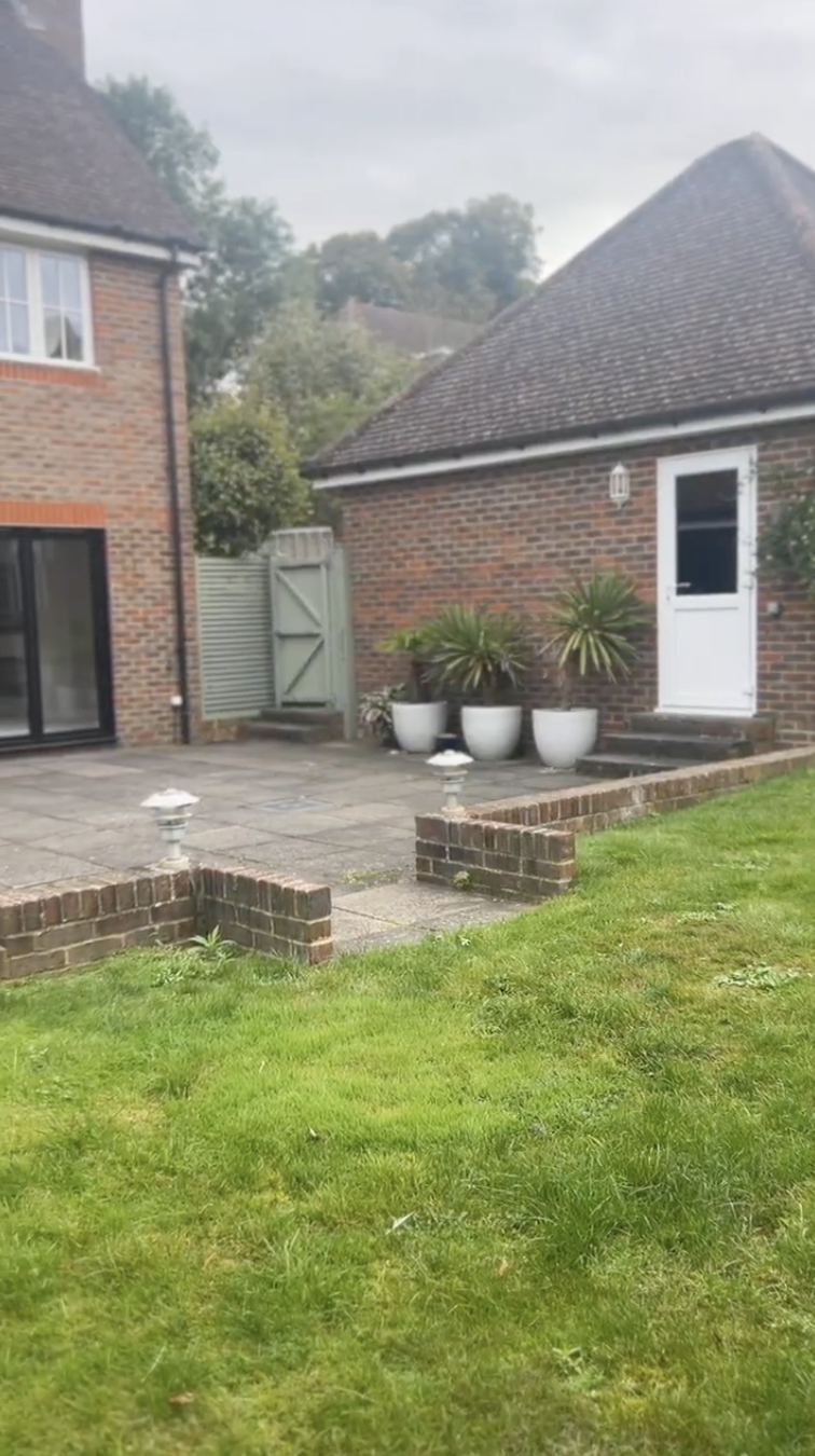 Original Dell garden — side path with planters and gated access